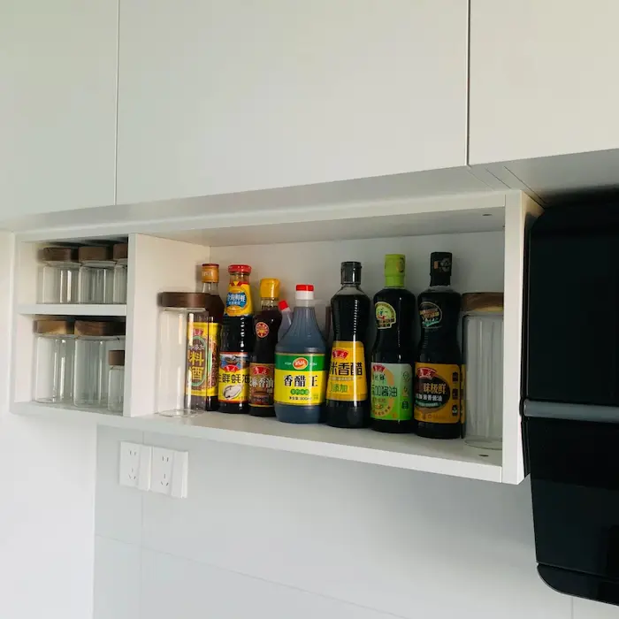Open shelves at the bottom of hanging cabinets
